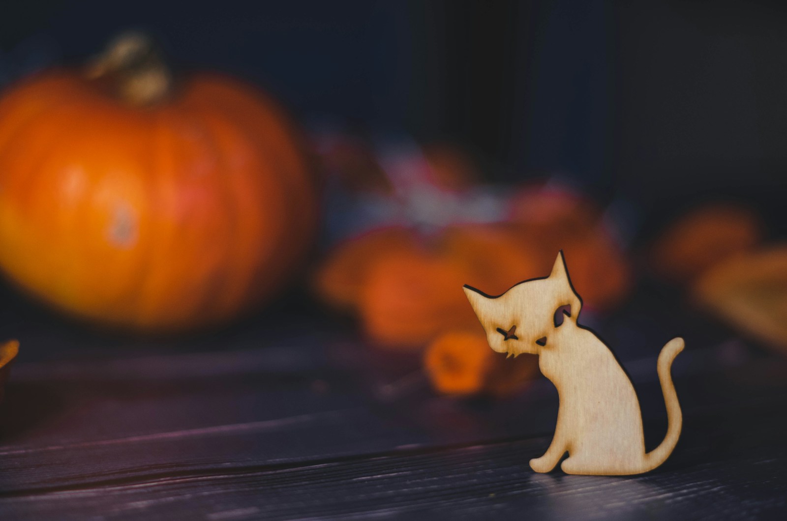 a wooden cat figurine sitting on a table